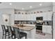 Bright kitchen features granite countertops, a central island, and stainless steel appliances at 208 Summerlin Ln, Haines City, FL 33844