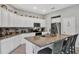 Bright kitchen features granite countertops, a central island, and stainless steel appliances at 208 Summerlin Ln, Haines City, FL 33844