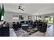 Spacious living room with tiled floors, comfortable seating, and an open layout to the dining area at 208 Summerlin Ln, Haines City, FL 33844