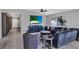 Bright living room with tiled floors, stylish furniture, and a large TV for entertainment at 208 Summerlin Ln, Haines City, FL 33844