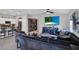 Open-concept living room flows into kitchen, featuring tiled floors, modern decor, and comfortable seating at 208 Summerlin Ln, Haines City, FL 33844