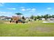 A well-maintained community playground has wood structures with multiple slides and shady canopy at 208 Summerlin Ln, Haines City, FL 33844