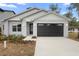 Charming single-story home featuring a modern exterior, neat landscaping, and an attached two-car garage at 2131 Brighton Ln, Orlando, FL 32817