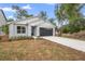 Well-maintained single-Gathering home featuring a two-car garage, manicured landscaping, and a modern design at 2131 Brighton Ln, Orlando, FL 32817