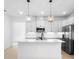 Bright kitchen features an island, stainless appliances, modern lighting, and neutral countertops at 2131 Brighton Ln, Orlando, FL 32817