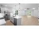 Bright kitchen with stainless steel appliances, modern island, and an open view to the light-filled living space at 2131 Brighton Ln, Orlando, FL 32817