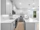 Modern kitchen with white cabinets, stainless steel appliances, quartz countertops, and an island with a sink at 2131 Brighton Ln, Orlando, FL 32817