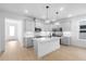 Bright, modern kitchen with stainless appliances, island, pendant lighting, and light wood floors at 2131 Brighton Ln, Orlando, FL 32817