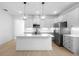 Bright kitchen with a center island, stainless steel appliances, and modern pendant lighting at 2131 Brighton Ln, Orlando, FL 32817