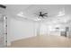 Open living room with neutral walls, ceiling fan, and views into the kitchen at 2131 Brighton Ln, Orlando, FL 32817