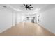 Spacious open-concept living area with wood floors and a seamless view of the modern kitchen at 2131 Brighton Ln, Orlando, FL 32817