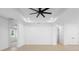 Open living room with neutral walls, ceiling fan, and entrances to multiple rooms at 2131 Brighton Ln, Orlando, FL 32817