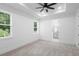 Spacious main bedroom with two windows, ceiling fan, and ensuite bathroom access at 2131 Brighton Ln, Orlando, FL 32817