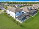 Aerial shot of the rear of a property showcasing the pool, lush lawn, and community landscaping at 2312 Panoramic Cir, Apopka, FL 32703