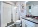 Bathroom featuring a walk-in shower with glass doors and a vanity with a gray countertop at 2312 Panoramic Cir, Apopka, FL 32703
