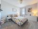 Comfortable bedroom with a flower-patterned bedspread and soft, neutral carpet at 2312 Panoramic Cir, Apopka, FL 32703