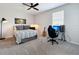 Bedroom featuring a bed with grey accents, a desk, and a ceiling fan at 2312 Panoramic Cir, Apopka, FL 32703
