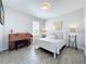 Cozy bedroom with a white bed frame, piano, and neutral decor at 2312 Panoramic Cir, Apopka, FL 32703
