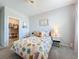 Inviting bedroom with a flower-patterned bedspread and a view into the closet at 2312 Panoramic Cir, Apopka, FL 32703