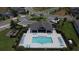 Aerial view of a community pool with a shaded pavilion, lounge chairs, and well-maintained landscaping at 2312 Panoramic Cir, Apopka, FL 32703