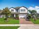 Charming two-story home with a brick driveway and well-manicured lawn at 2312 Panoramic Cir, Apopka, FL 32703