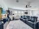 Upstairs game room with theater style seating, tv, and a large window to the neighborhood at 2312 Panoramic Cir, Apopka, FL 32703