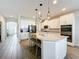 Elegant kitchen featuring an island, modern lighting, and stainless steel appliances at 2312 Panoramic Cir, Apopka, FL 32703