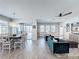 Open-concept living and dining area with wood-look tile flooring and lots of natural light at 2312 Panoramic Cir, Apopka, FL 32703