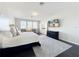 Bright main bedroom with sitting area, dark wood floors, and wall-mounted television at 2312 Panoramic Cir, Apopka, FL 32703