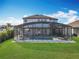 Large home with a screened pool, a well manicured lawn, and white stone borders at 2312 Panoramic Cir, Apopka, FL 32703
