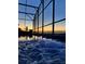 Beautiful, bubbling pool at dusk with string lights and screened enclosure create the perfect ambiance at 2312 Panoramic Cir, Apopka, FL 32703