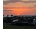 Stunning sunset view over rooftops, showcasing a beautiful sky and community ambiance near the water at 2312 Panoramic Cir, Apopka, FL 32703