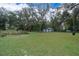 Large backyard with mature shade trees and detached shed at 237 Church St, Lake Helen, FL 32744
