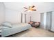 Comfortable bedroom features tile floors, ceiling fan, neutral decor, and plenty of natural light at 237 Church St, Lake Helen, FL 32744