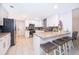 Well-lit modern kitchen with granite countertops, stainless steel appliances, gray accent tiles, and breakfast bar at 237 Church St, Lake Helen, FL 32744