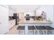Updated modern kitchen features granite countertops, stainless steel appliances, white cabinets, gray backsplash, and breakfast bar at 237 Church St, Lake Helen, FL 32744