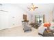 Spacious living room featuring vaulted ceilings, neutral walls, tile flooring, and an access door to the lanai at 237 Church St, Lake Helen, FL 32744
