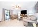 Cozy living room features tile floors, ceiling fan, sliding glass doors, and comfortable seating arrangement at 237 Church St, Lake Helen, FL 32744