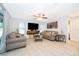 Bright living room showcases neutral tones, tile floors, ceiling fan, and large windows for ample natural light at 237 Church St, Lake Helen, FL 32744