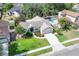 Aerial view showcasing a single Gathering home, a pool, lush greenery, and manicured lawns in a suburban neighborhood at 249 Mill Slough Rd, Oviedo, FL 32766