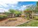 The backyard has a wooden fence with flower beds along the perimeter and a decorative arbor creating a tranquil garden at 249 Mill Slough Rd, Oviedo, FL 32766