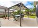 Backyard featuring a covered patio with outdoor dining furniture and manicured yard at 249 Mill Slough Rd, Oviedo, FL 32766