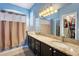 Bathroom with double sinks, granite countertops, and a walk-in closet at 249 Mill Slough Rd, Oviedo, FL 32766