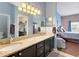 Bright bathroom featuring double sinks with granite countertops and view to bedroom and walk-in closet at 249 Mill Slough Rd, Oviedo, FL 32766