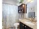 Bathroom with dark cabinets, granite countertops, and decorative shower curtain at 249 Mill Slough Rd, Oviedo, FL 32766