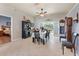 Dining room with tile flooring, and furniture which features two grandfather clocks and an ornate chandelier at 249 Mill Slough Rd, Oviedo, FL 32766