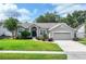 The front exterior features a manicured lawn, an arched doorway, and a two-car garage, showing curb appeal at 249 Mill Slough Rd, Oviedo, FL 32766