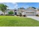 Charming home featuring a well-manicured lawn, tidy landscaping, and a two-car garage at 249 Mill Slough Rd, Oviedo, FL 32766