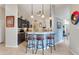 Stylish kitchen with dark cabinetry, granite countertops, and breakfast bar with seating at 249 Mill Slough Rd, Oviedo, FL 32766