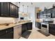 Modern kitchen featuring dark cabinetry, stainless steel appliances, and granite countertops at 249 Mill Slough Rd, Oviedo, FL 32766